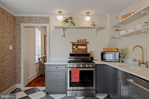 a kitchen with stainless steel appliances a stove and a sink