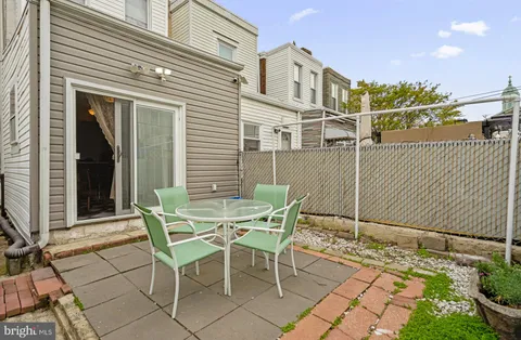 a view of a patio with table and chairs and potted plants