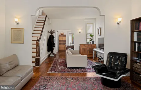 a living room with furniture a rug and a window