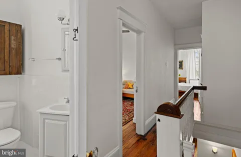 a bathroom with a toilet a sink and mirror