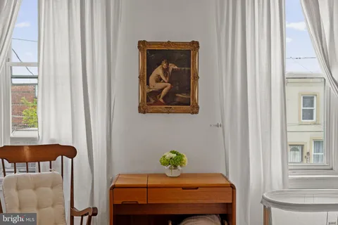 a bedroom with a table and chair