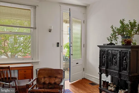 a view of a livingroom with furniture and hardwood floor