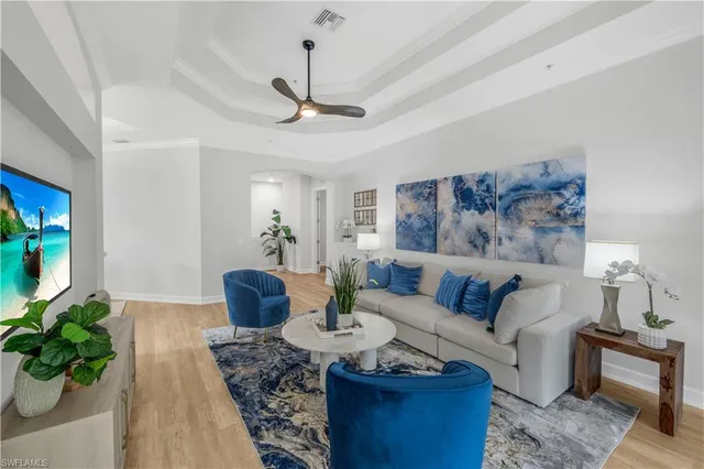 a living room with furniture or chandelier and a wooden floor