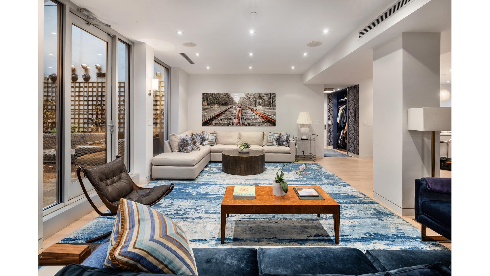 433 East 74th Street, Unit TH/1B Manhattan, NY 10021 - Photo 1 of 15 a living room with furniture a rug and kitchen view