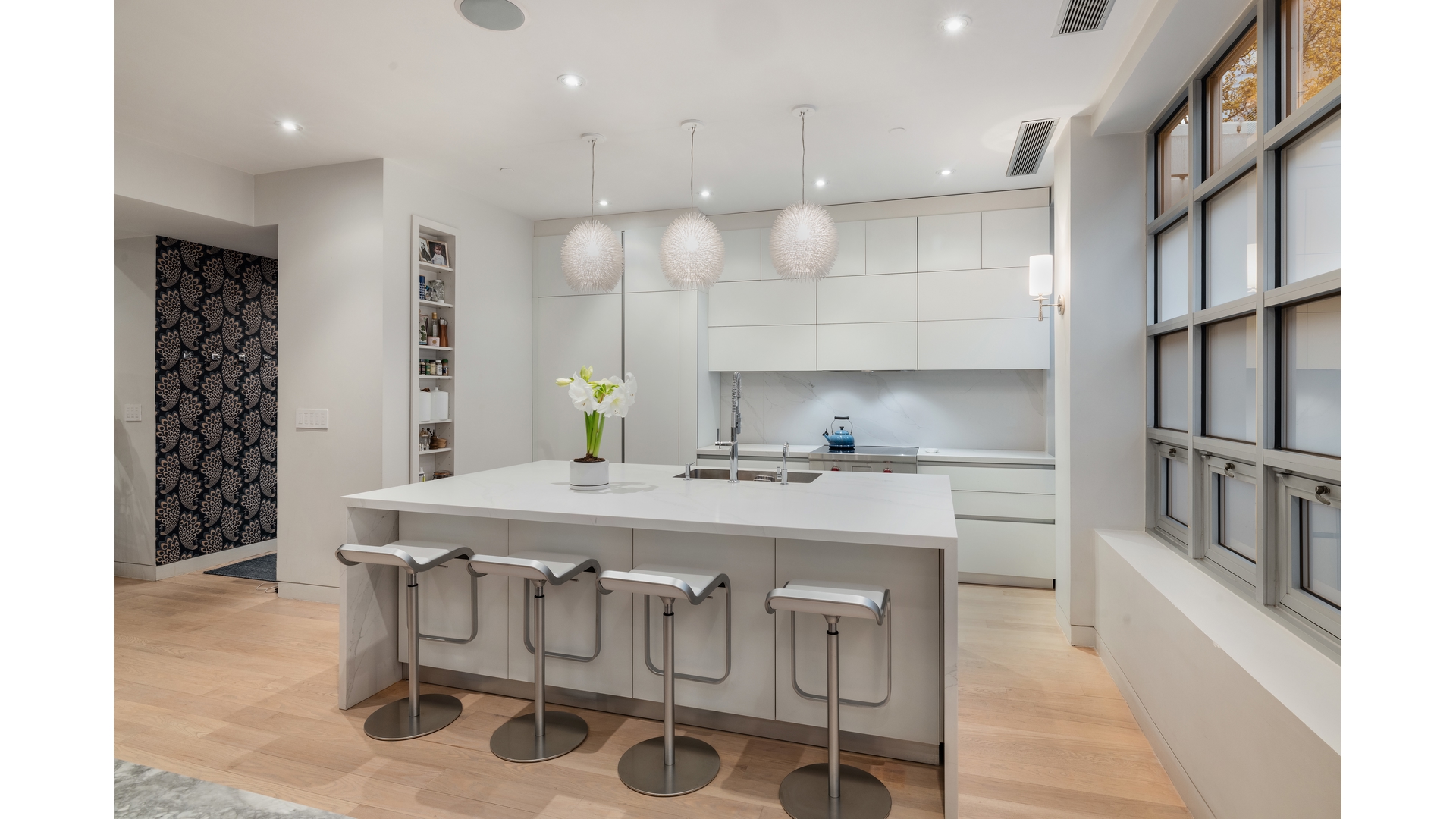 433 East 74th Street, Unit TH/1B Manhattan, NY 10021 - Photo 5 of 15 a kitchen with a table chairs sink and cabinets