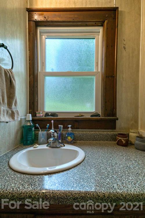 1943 Beaverdam Road Canton, NC 28716 - Photo 14 of 31 a bathroom with a granite countertop sink and a mirror