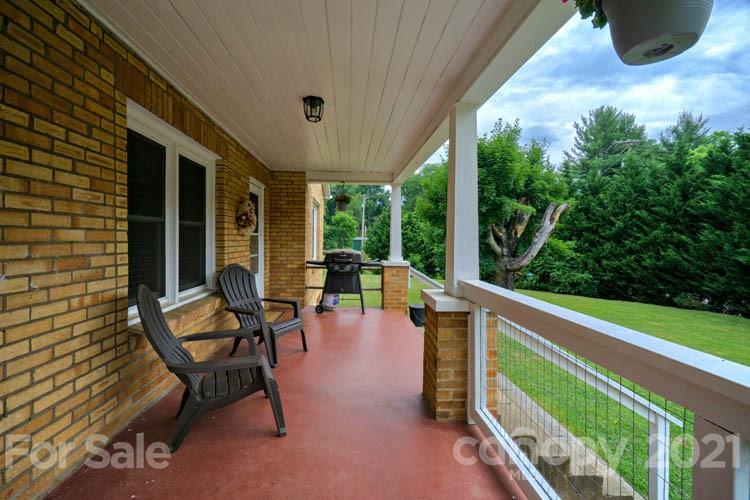 1943 Beaverdam Road Canton, NC 28716 - Photo 24 of 31 a balcony with chairs and a table