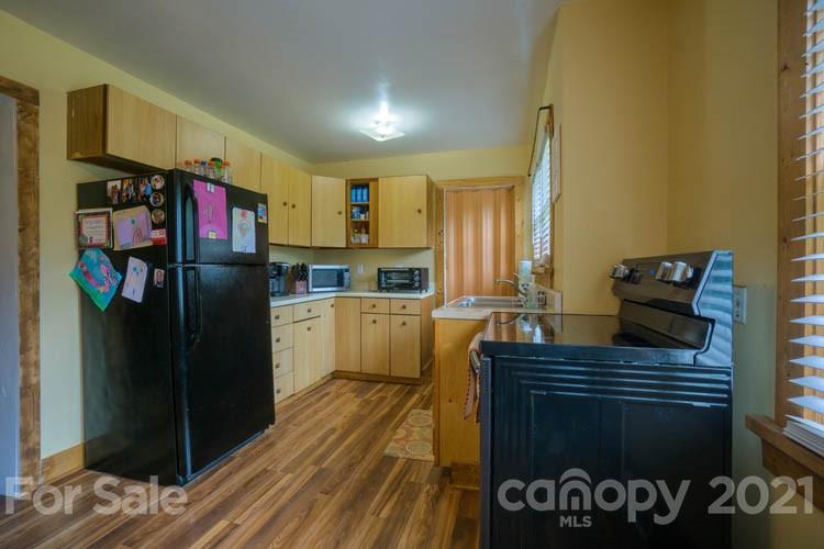 1943 Beaverdam Road Canton, NC 28716 - Photo 4 of 31 a kitchen with a refrigerator and a sink