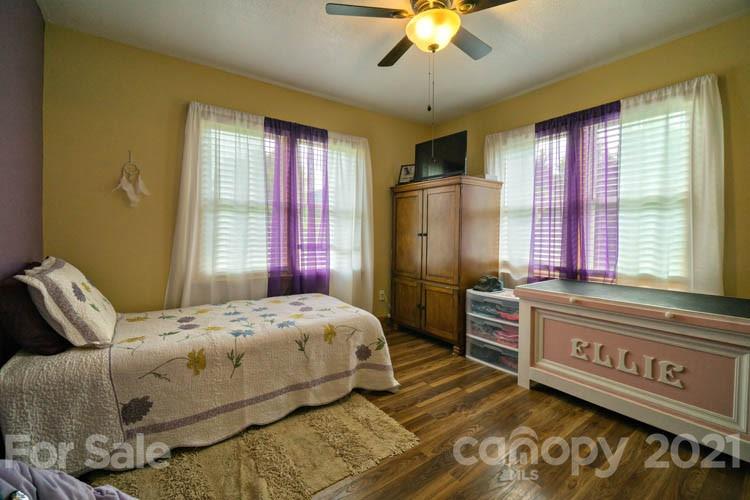 1943 Beaverdam Road Canton, NC 28716 - Photo 5 of 31 a bedroom with a bed and a chandelier