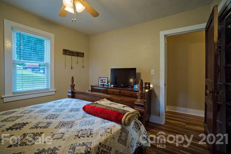 1943 Beaverdam Road Canton, NC 28716 - Photo 9 of 31 a bedroom with a bed and a flat screen tv
