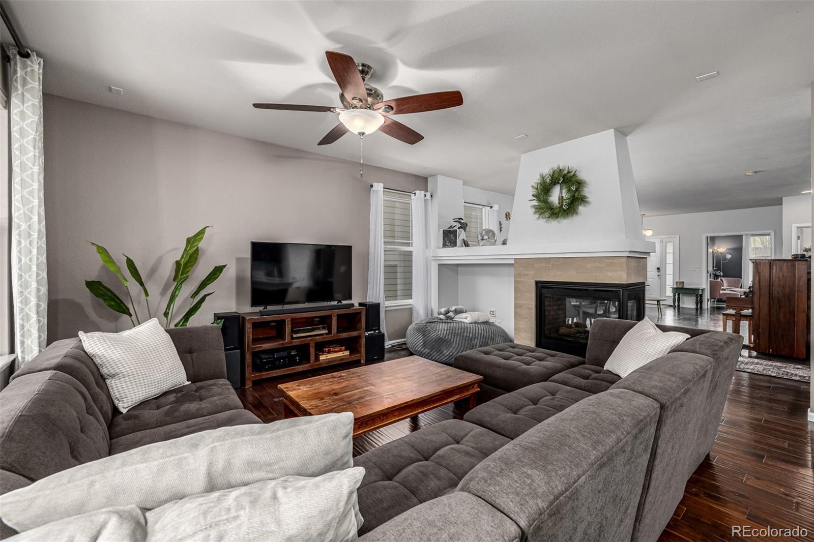 1138 Mircos Street Erie, CO 80516 - Photo 11 of 46 a living room with furniture a flat screen tv and a fireplace