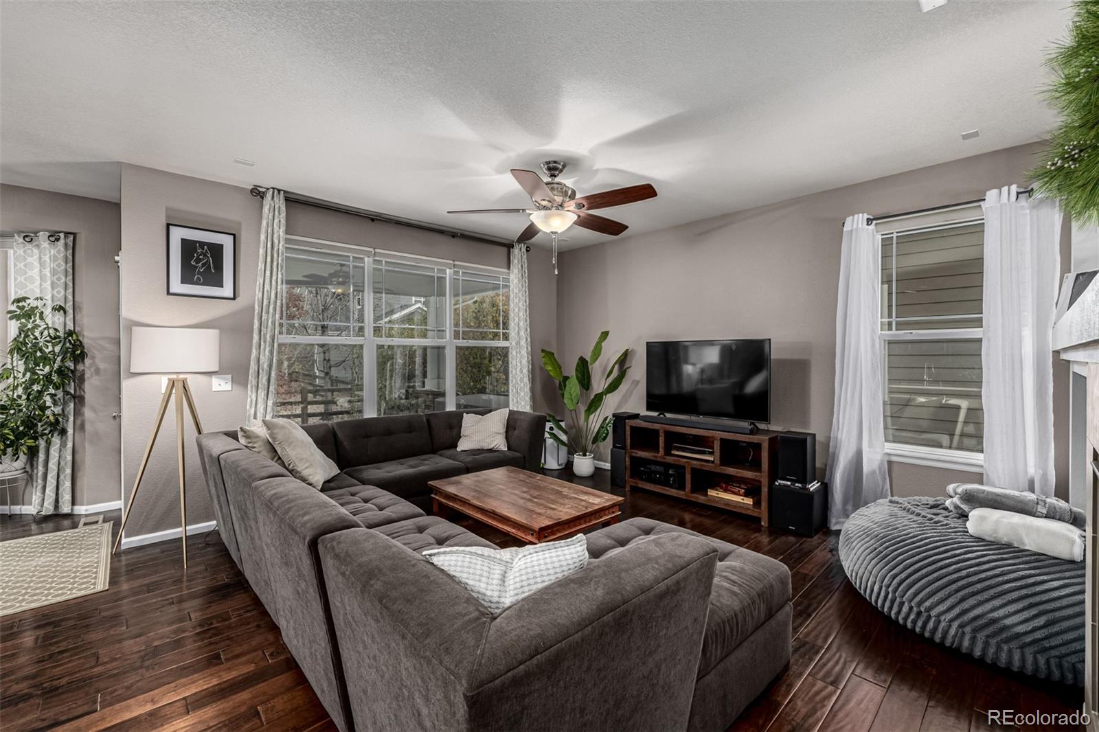 1138 Mircos Street Erie, CO 80516 - Photo 12 of 46 a living room with furniture a flat screen tv and a large window