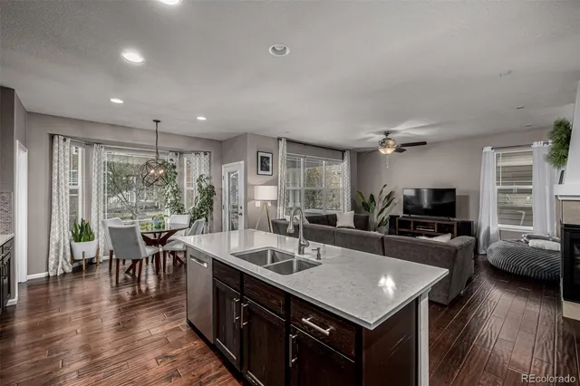 a kitchen with stainless steel appliances granite countertop a sink stove and wooden floor