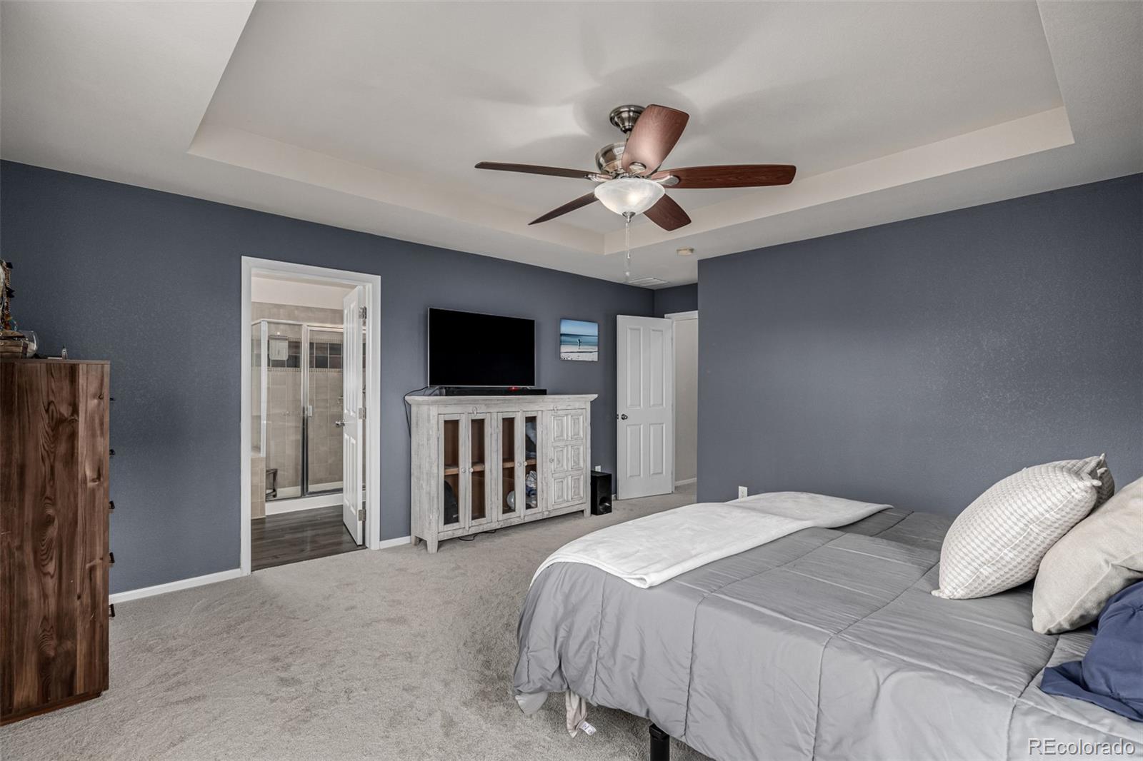 1138 Mircos Street Erie, CO 80516 - Photo 24 of 46 a bedroom with a bed and a flat screen tv