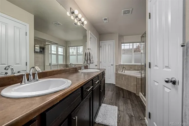 a bathroom with a granite countertop sink a toilet and a mirror