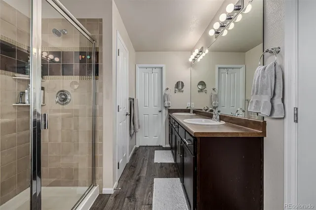 a bathroom with a sink double vanity and shower
