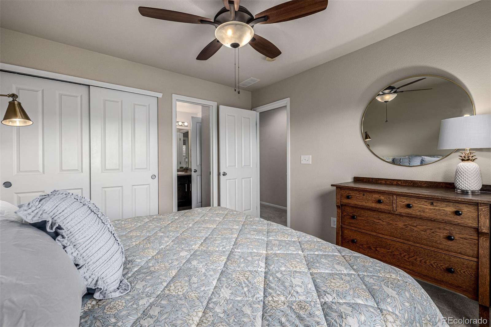 1138 Mircos Street Erie, CO 80516 - Photo 29 of 46 a bedroom with a bed and a chandelier