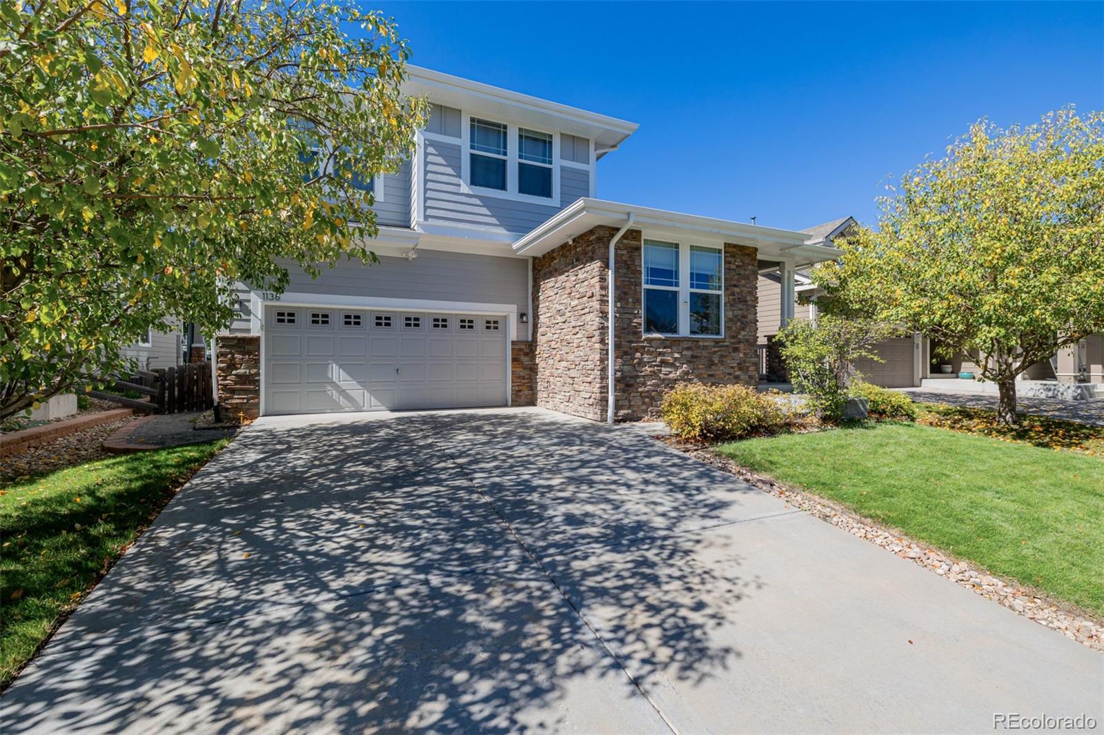 1138 Mircos Street Erie, CO 80516 - Photo 3 of 46 a front view of a house with a yard and garage