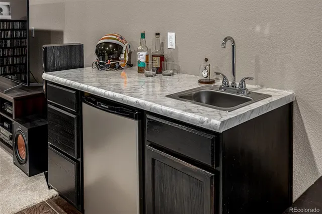 a kitchen with a sink and a refrigerator