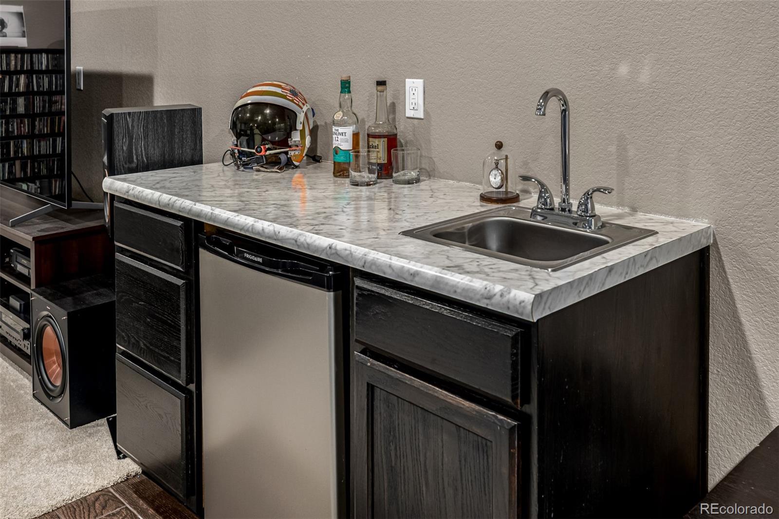 1138 Mircos Street Erie, CO 80516 - Photo 36 of 46 a kitchen with a sink and a refrigerator