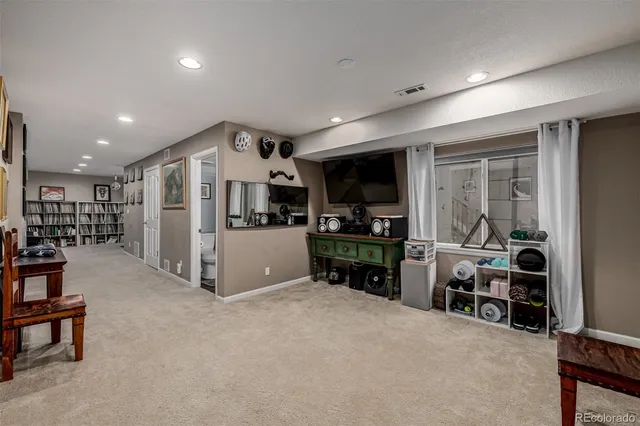 a kitchen with stainless steel appliances kitchen island granite countertop a refrigerator and a sink