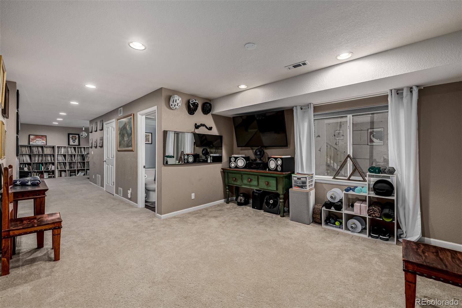 1138 Mircos Street Erie, CO 80516 - Photo 37 of 46 a kitchen with stainless steel appliances kitchen island granite countertop a refrigerator and a sink
