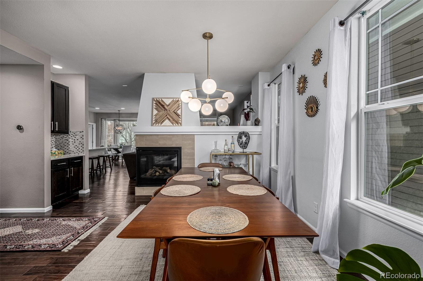1138 Mircos Street Erie, CO 80516 - Photo 8 of 46 a dining room with furniture a chandelier and wooden floor