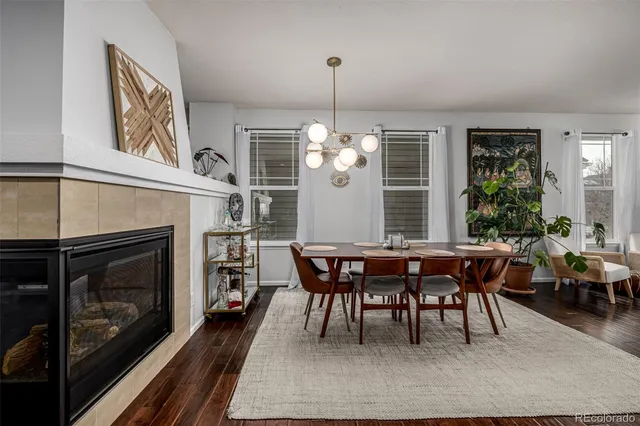 a dining room with a table chairs and a fireplace