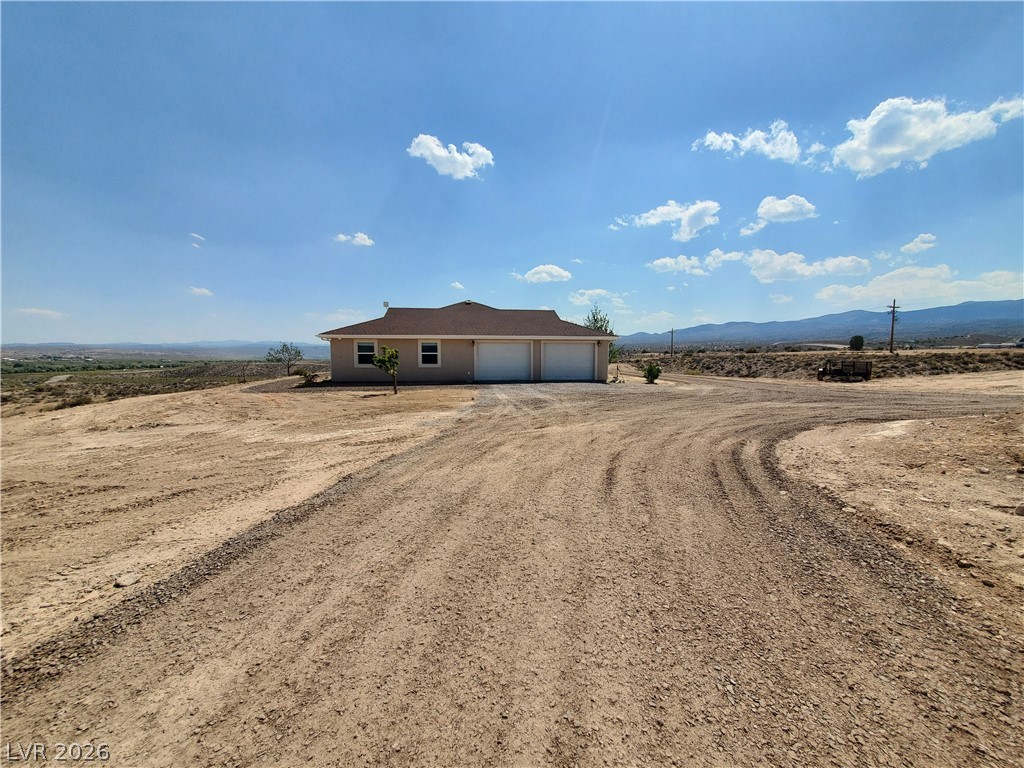 5272 Truman Lane Caliente, NV 89008 - Photo 25 of 43 Ranch-style home featuring driveway, a garage, and a mountain view
