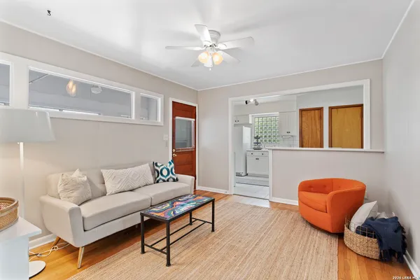 a living room with furniture and wooden floor