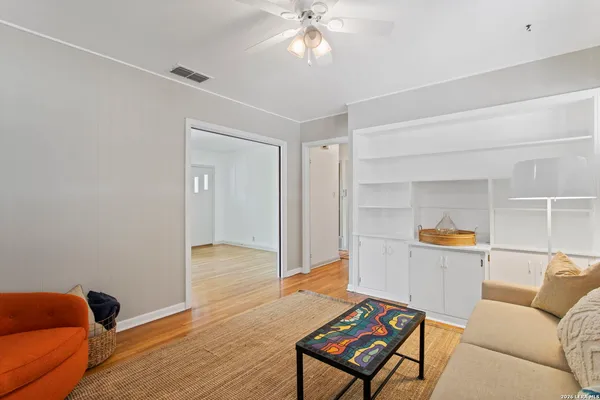 a living room with furniture and wooden floor