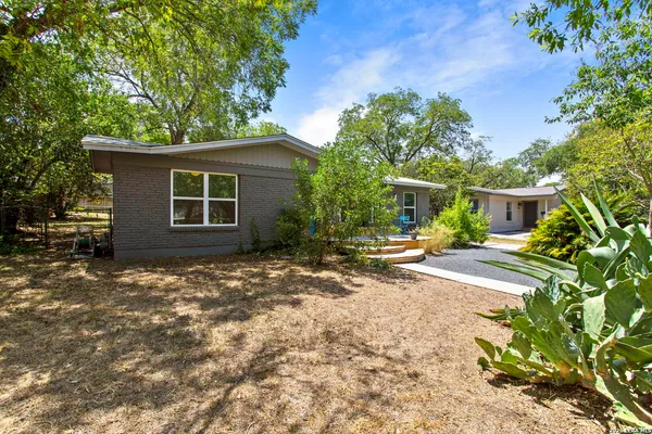 a view of a house with a yard and garage