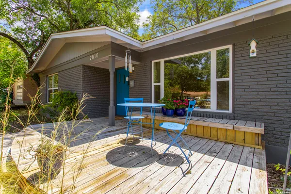 a view of a house with pool and sitting area
