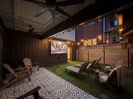 a view of a deck front of house with green space