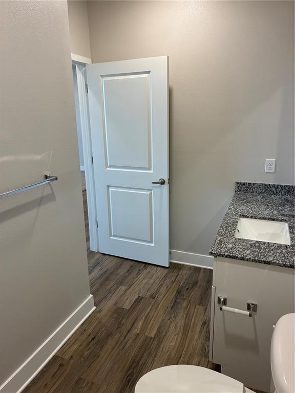 801 Naval Ave Mount, Unit 2203 Mount Dora, FL 32757 - Photo 2 of 16 a bathroom with a granite countertop toilet and a sink