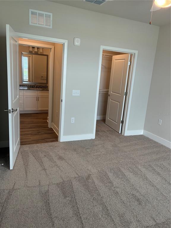 801 Naval Ave Mount, Unit 2203 Mount Dora, FL 32757 - Photo 4 of 16 an empty room with a mirror and a sink