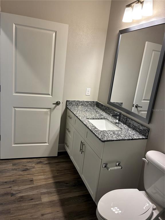801 Naval Ave Mount, Unit 2203 Mount Dora, FL 32757 - Photo 10 of 16 a bathroom with a granite countertop toilet sink and mirror