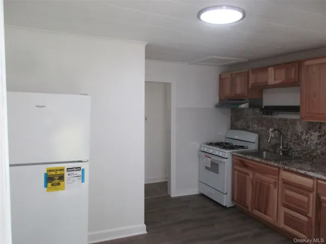 a kitchen with a stove a sink and cabinets