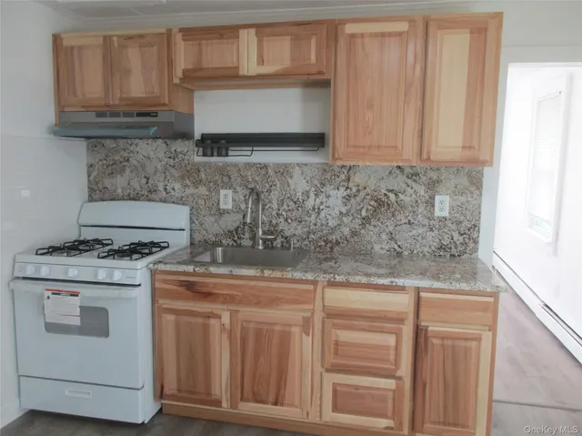 a kitchen with granite countertop cabinets stainless steel appliances and a sink