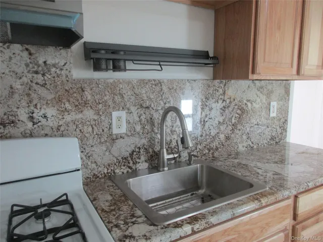a kitchen with a sink and a stove