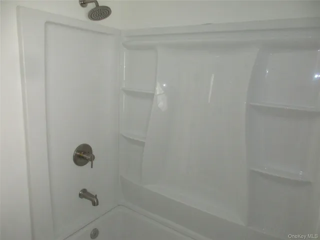 a bathroom with a sink mirror and toilet