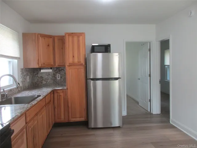 a kitchen with stainless steel appliances granite countertop a refrigerator a sink and dishwasher