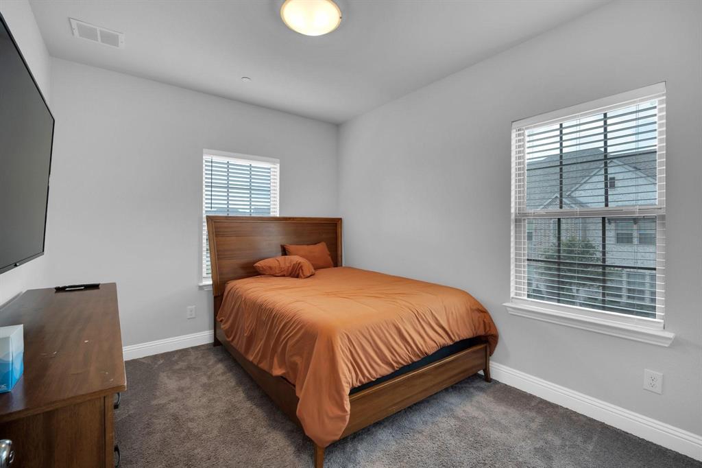 1498 Weston Road Dallas, TX 75234 - Photo 19 of 24 Carpeted room featuring two windows with horizontal blinds, light gray walls, and a flush mount ceiling light