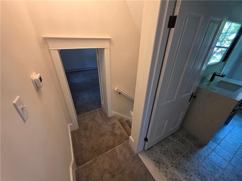 601 Cherry Hill Road Nazareth, PA 18064 - Photo 20 of 27 A well-appointed staircase with plush carpeted steps leads to a tiled landing, hinting at diverse flooring.
