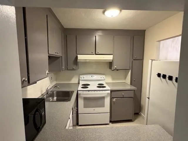 a kitchen with a stove and a refrigerator