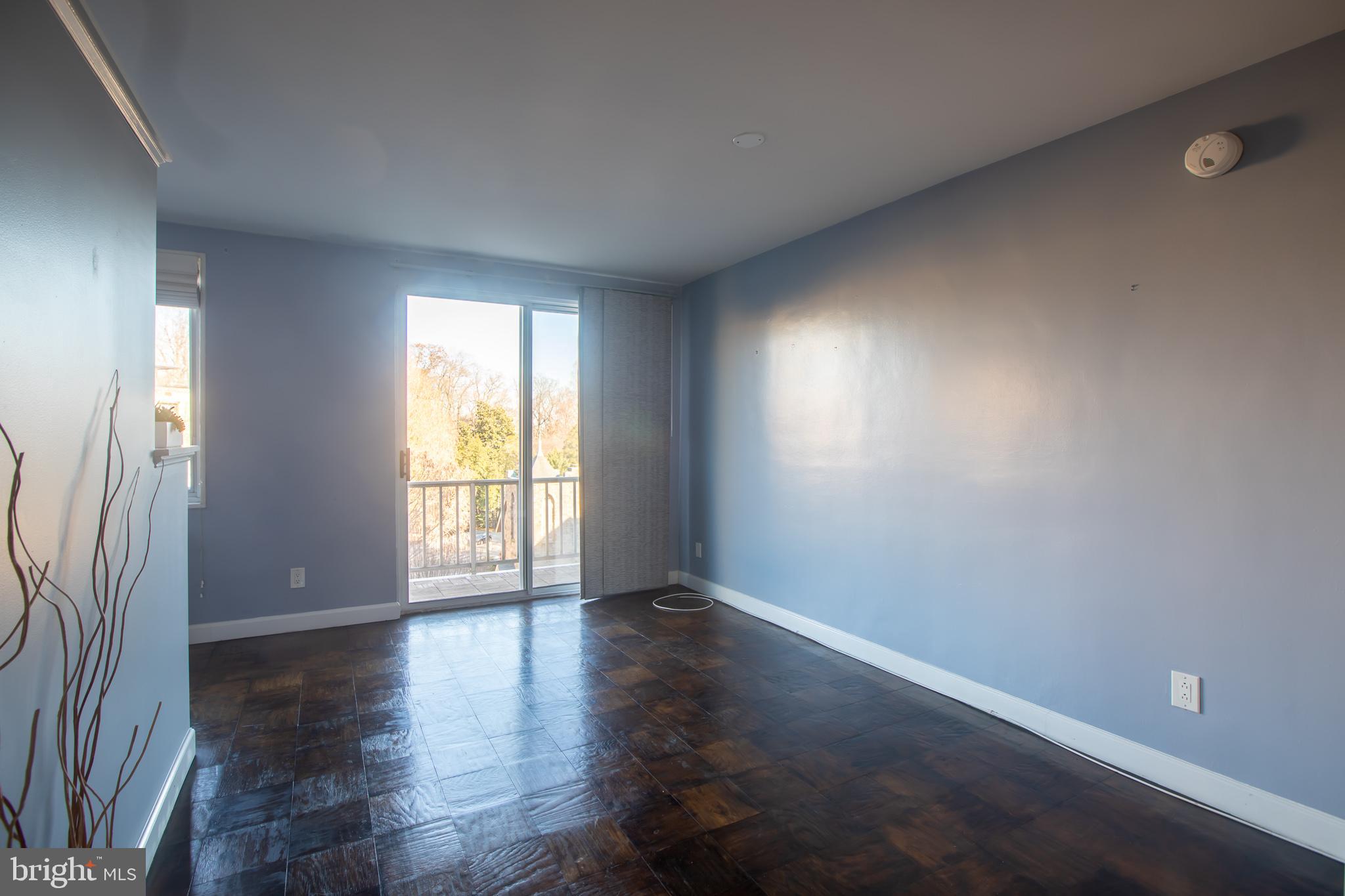 2829 Connecticut Avenue Northwest, Unit 505 Washington, DC 20008 - Photo 10 of 17 an empty room with wooden floor and windows