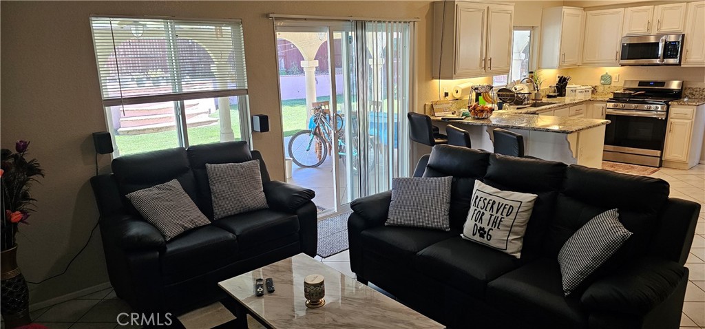 1650 Ravenswood Road Beaumont, CA 92223 - Photo 18 of 42 a living room with furniture and a flat screen tv