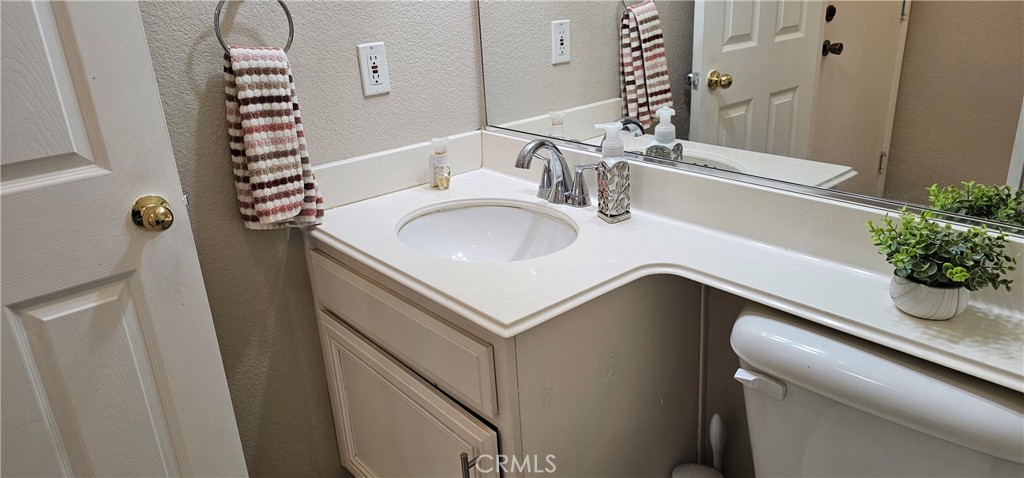 1650 Ravenswood Road Beaumont, CA 92223 - Photo 19 of 42 a bathroom with a sink and a mirror