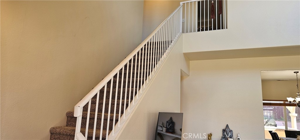 1650 Ravenswood Road Beaumont, CA 92223 - Photo 20 of 42 a view of staircase with railing and white walls