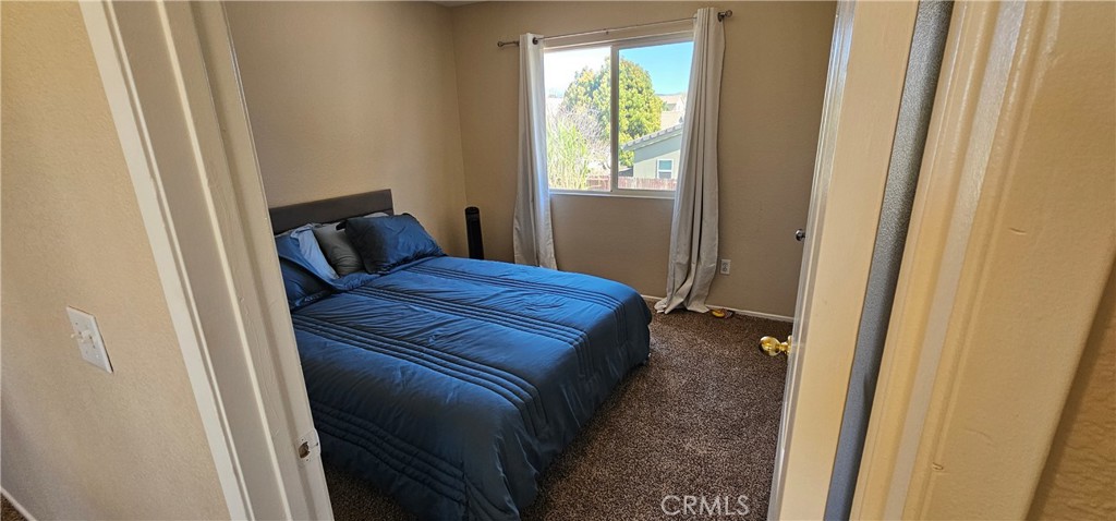 1650 Ravenswood Road Beaumont, CA 92223 - Photo 25 of 42 a bedroom with a bed and a window